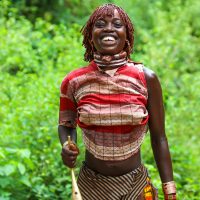 A Hamar Women Jumps with her Horn, Turmi, Ethiopia