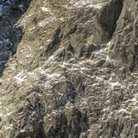The Priecne sedlo via ferrata, see small climbers halfway up just under the shadow-line, High Tatras, Slovakia