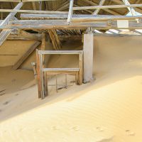 The Exterior of a House Almost Completely Covered by a Dune, Kolmanskop Ghost Town, Namibia