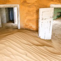 Sand Dunes Flowing through a House, Komanskop Ghost Town, Namibia